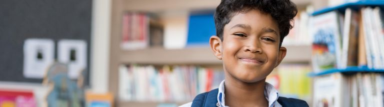 boy smiling with backpack