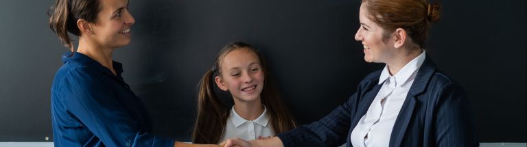 Parent and teacher shaking hands