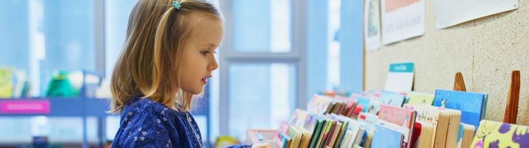 Young girl choosing a book to read