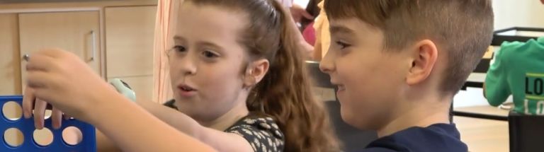 Two children playing connect four