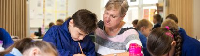 A teacher helping a student with a writing task